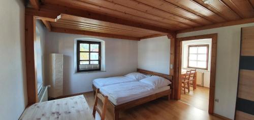 a bedroom with a bed and a window in it at Ferienwohnungen Hafnerkarl in Falkenberg