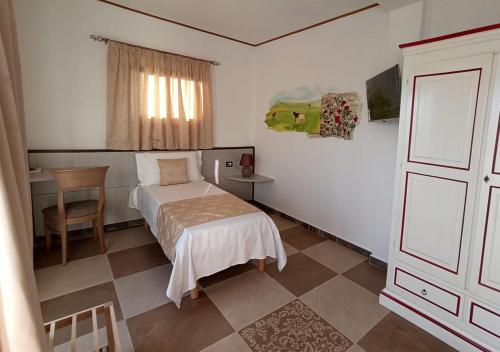 En eller flere senger på et rom på Locanda Arcadia