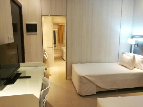 a hotel room with a bed and a table at Hotel Nuevo Ostende by bund in Mar del Plata