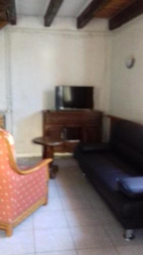 a living room with a desk and a couch at petite maison au paradis in La Neuvelle-lès-Scey