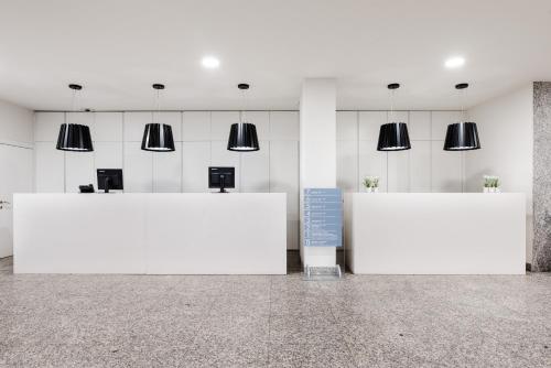 two large white tables in a room with lights at Eurostars Mar de Vigo in Vigo