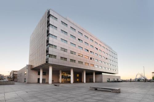 a large office building in a parking lot at Eurostars Mar de Vigo in Vigo
