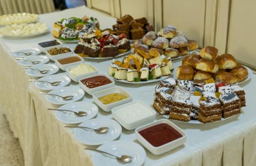a table with many different types of pastries and desserts at Kasimir Resort Hotel & SPA in Bukovel