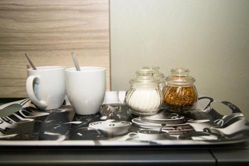 a tray with cups and plates on a table at Ndzuti Guest House in Witbank