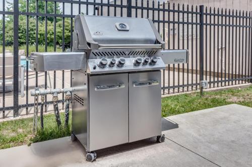 a grill sitting on a sidewalk next to a fence at Holiday Inn Express Exton - Great Valley by IHG in Exton