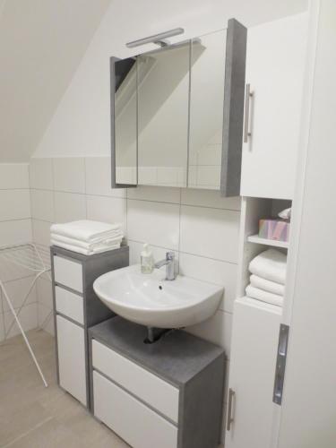 a bathroom with a sink and a mirror and towels at Landhaus Ziegelstadel in Windischgarsten