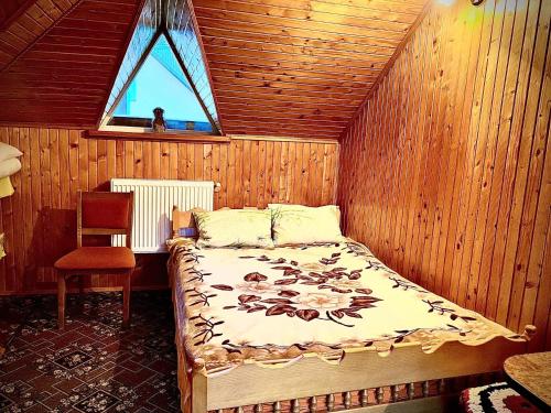 a bedroom with a bed in a room with a window at VХаті in Slavske