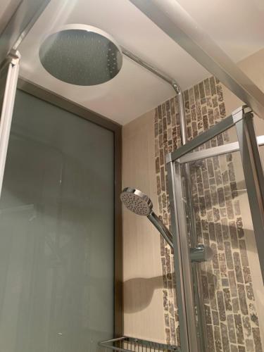 a shower with a shower head in a bathroom at Forever FOZ in Foz