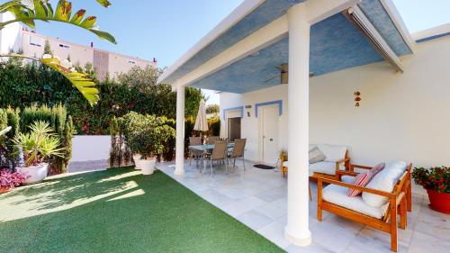 a patio with a green rug and a house at Villa Juan Miguel by Family Homes in Denia