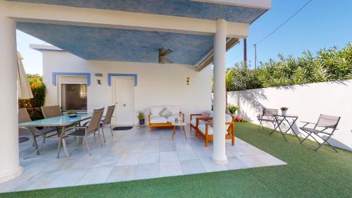 a patio with a table and chairs and a dining room at Villa Juan Miguel by Family Homes in Denia