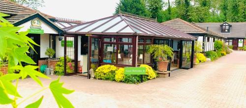 a building with a lot of plants and flowers at The Stanwick Hotel in Stanwick