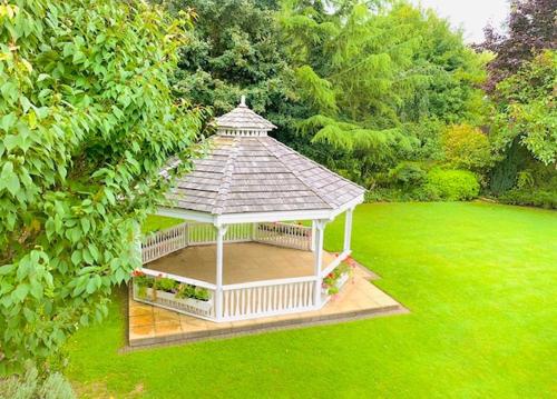 a gazebo in the middle of a lawn at The Stanwick Hotel in Stanwick
