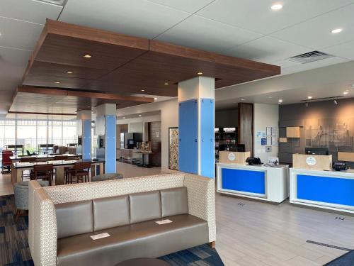 an office lobby with a couch and a table at Holiday Inn Express & Suites - Madison West - Middleton by IHG in Middleton