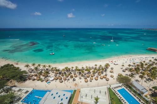 an aerial view of a beach with umbrellas and chairs at Riu Palace Antillas - Adults Only - All Inclusive in Palm-Eagle Beach