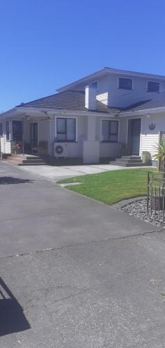a house with a driveway in front of it at Thistle B&B in Napier