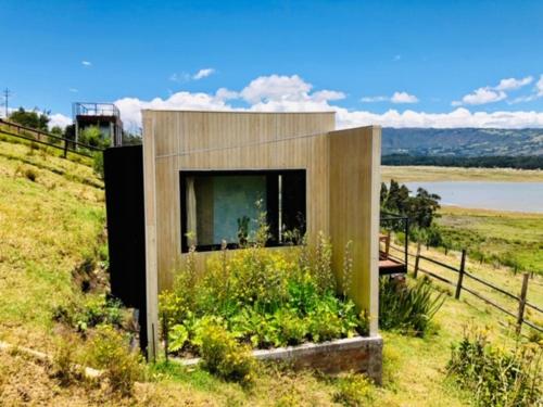 a building on top of a hill in a field at Romantico Galileo in Guatavita