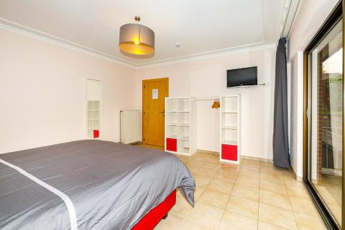 a bedroom with a bed and a flat screen tv at Luxueuse et spacieuse villa avec sauna et piscine in Malmedy