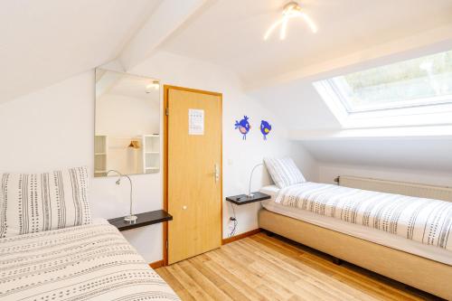 two beds in a room with a window at Luxueuse et spacieuse villa avec sauna et piscine in Malmedy