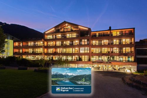 a large building with a sign in front of it at Schönblick Residence Apartments - including summer & mobility card in Zell am See