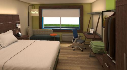 a hotel room with a bed and a desk and a chair at Holiday Inn Express Atmore by IHG in Atmore