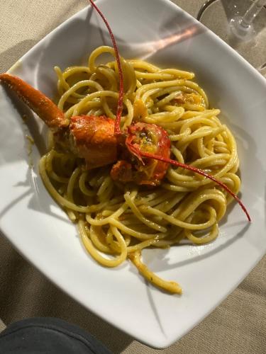 a plate of pasta with a shrimp on top at Agriturismo Fiori d'Arancio in Palagiano