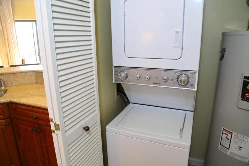 a white washer and dryer in a small kitchen at Club Wyndham Ka Eo Kai in Princeville