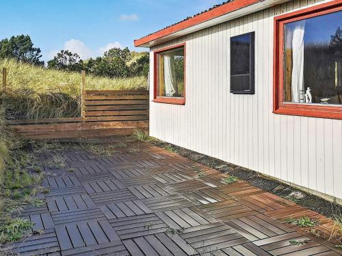 a patio next to a house with a window at 5 person holiday home in Hvide Sande in Hvide Sande