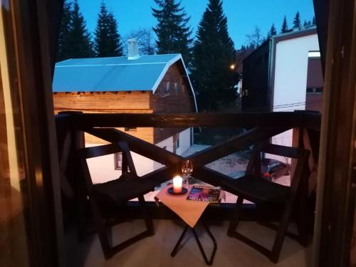 a window view of a table and a barn at Apartman Jahorina in Jahorina