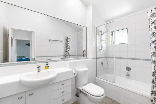 a bathroom with a sink and a toilet and a shower at Beachies 1 in Point Lookout