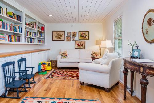 a living room with a couch and chairs and a table at Fire Pit * Pool * Hot Tub * Fishing Pond w/ Jon Boat in Easley