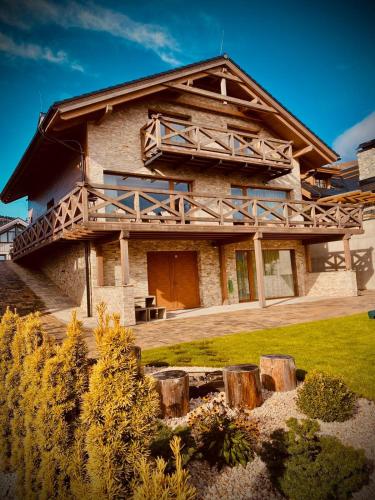 a large log house with a porch and a deck at Chalet Rebeca 6 beds Donovaly in Donovaly