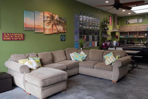 a living room with two couches and a kitchen at California Dreams Hostel - Pacific Beach in San Diego