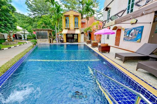 a swimming pool in front of a building at Ville De La Vie Khao Yai in Mu Si