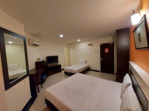 a hotel room with a bed and a television at HOTEL SAHARA SDN BHD in Rawang