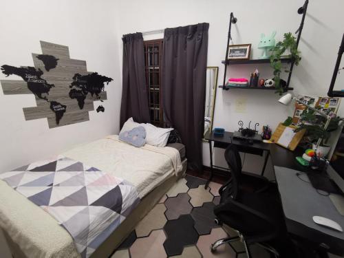 a bedroom with a desk and a bed and a desk and a computer at 5M cozy Homestay Bukit Mahkota Kajang in Kajang