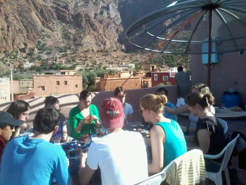 a group of people sitting around a table at Auberge Gitelkst in Tafraoute