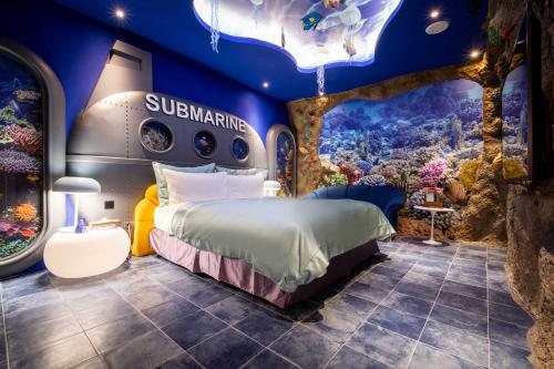 a room with a bed in a submarine themed room at AURORA MOTEL in Taichung