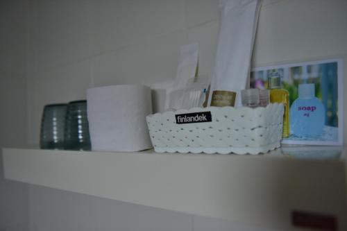 a shelf with toilet paper and toiletries on it at KT Knight Hotel in Surin
