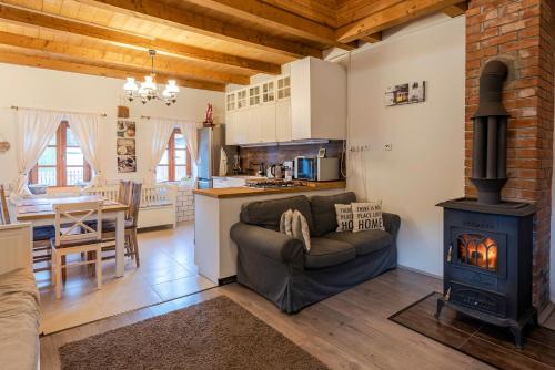 a living room with a couch and a wood stove at HepeHuta Házikó in Háromhuta