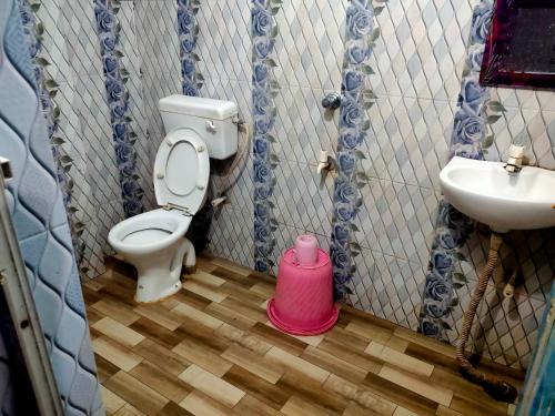 a bathroom with a toilet and a sink at Milan Guest House in Digha