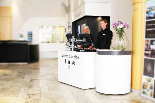 a man and woman standing at a counter in a store at Gothia Towers & Upper House in Gothenburg
