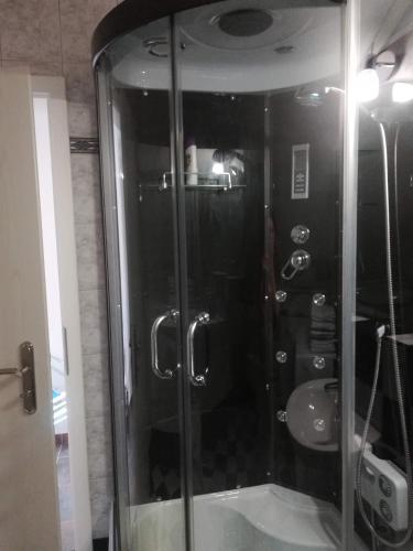 a shower with a glass door in a bathroom at Drago Kremenjaš in Delnice