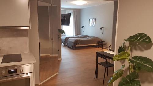 a hotel room with a bedroom with a bed and a table at Apartments Uppsala - Portalgatan in Uppsala