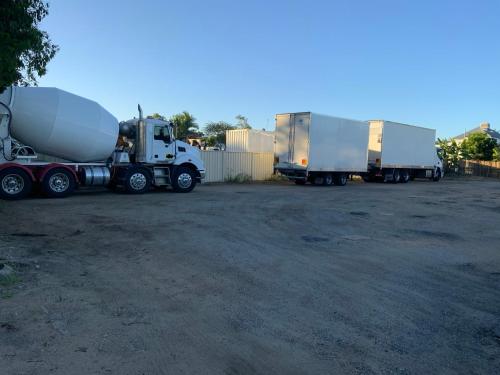 three semi trucks parked in a parking lot at Top 1 Motel in Rockhampton