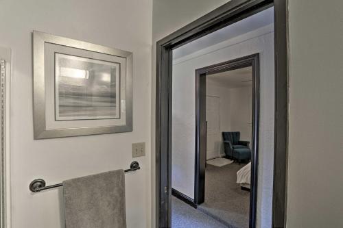 a bathroom with a mirror and a hallway with a chair at Modern Entertainment Getaway Off Sacramento River! in Anderson