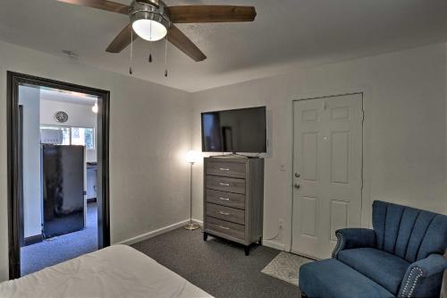a bedroom with a bed and a tv and a chair at Modern Entertainment Getaway Off Sacramento River! in Anderson