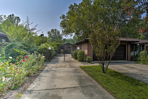 a driveway leading to a house with a gate at Modern Entertainment Getaway Off Sacramento River! in Anderson