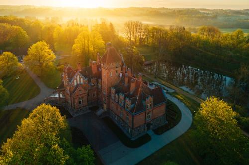 an aerial view of an old castle with trees at Jaunmoku Palace Complex Hotel in Tume