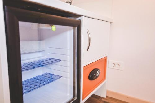an open refrigerator with blue bottles in it at Old Town Inn in Rijeka
