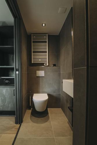a bathroom with a toilet and a sink at Hotel Bell in Zandvoort